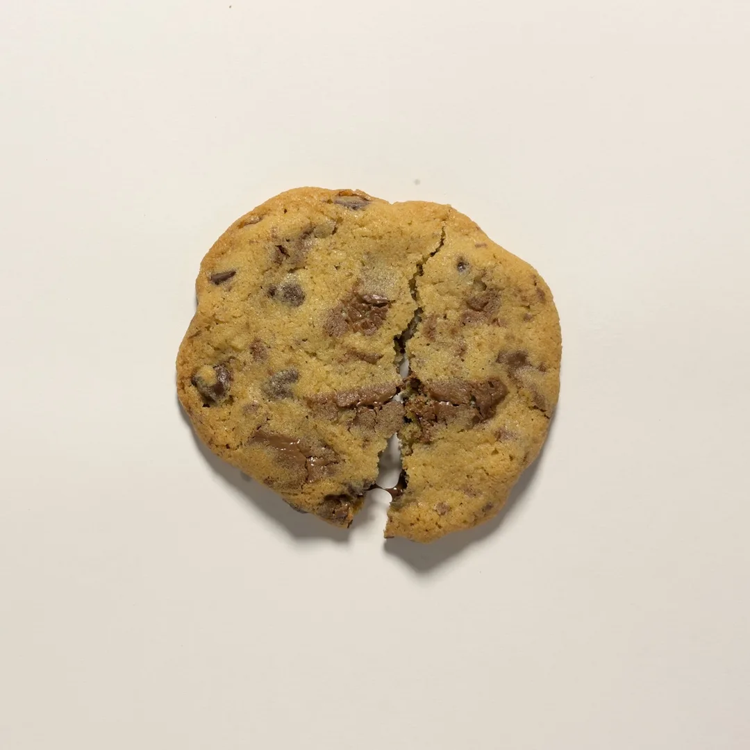 Chocolate Chunk cookie broken in two, showing its center