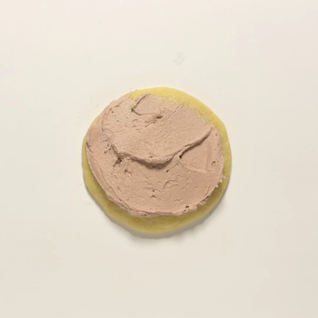 Frosted Sugar cookie topped with pink frosting