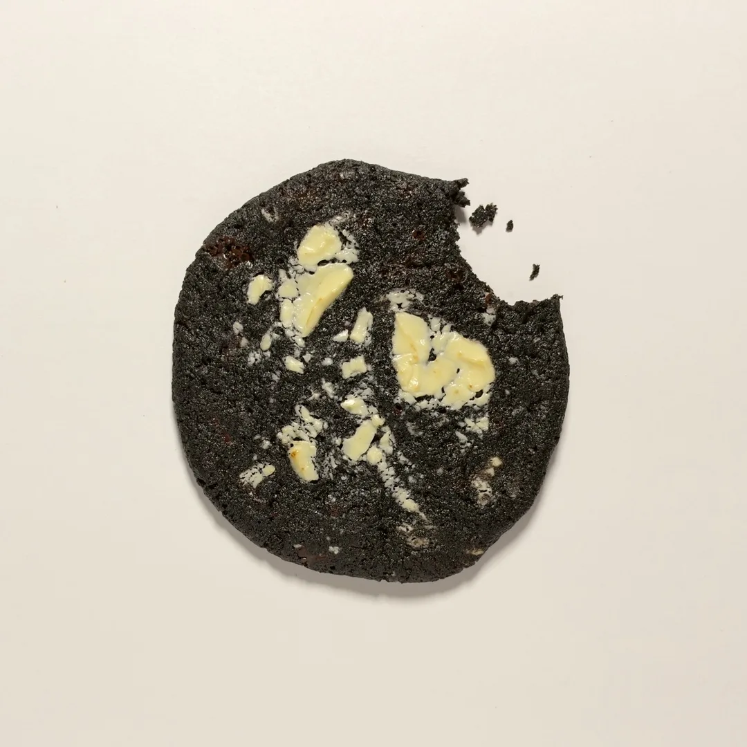 Triple Chocolate cookie with dark and white chocolate chunks and a bite taken out