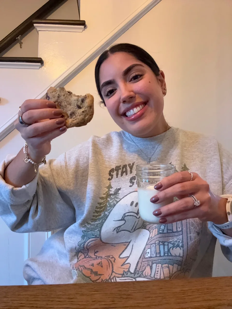 Enjoying a chocolate chunk cookie with a glass of milk.